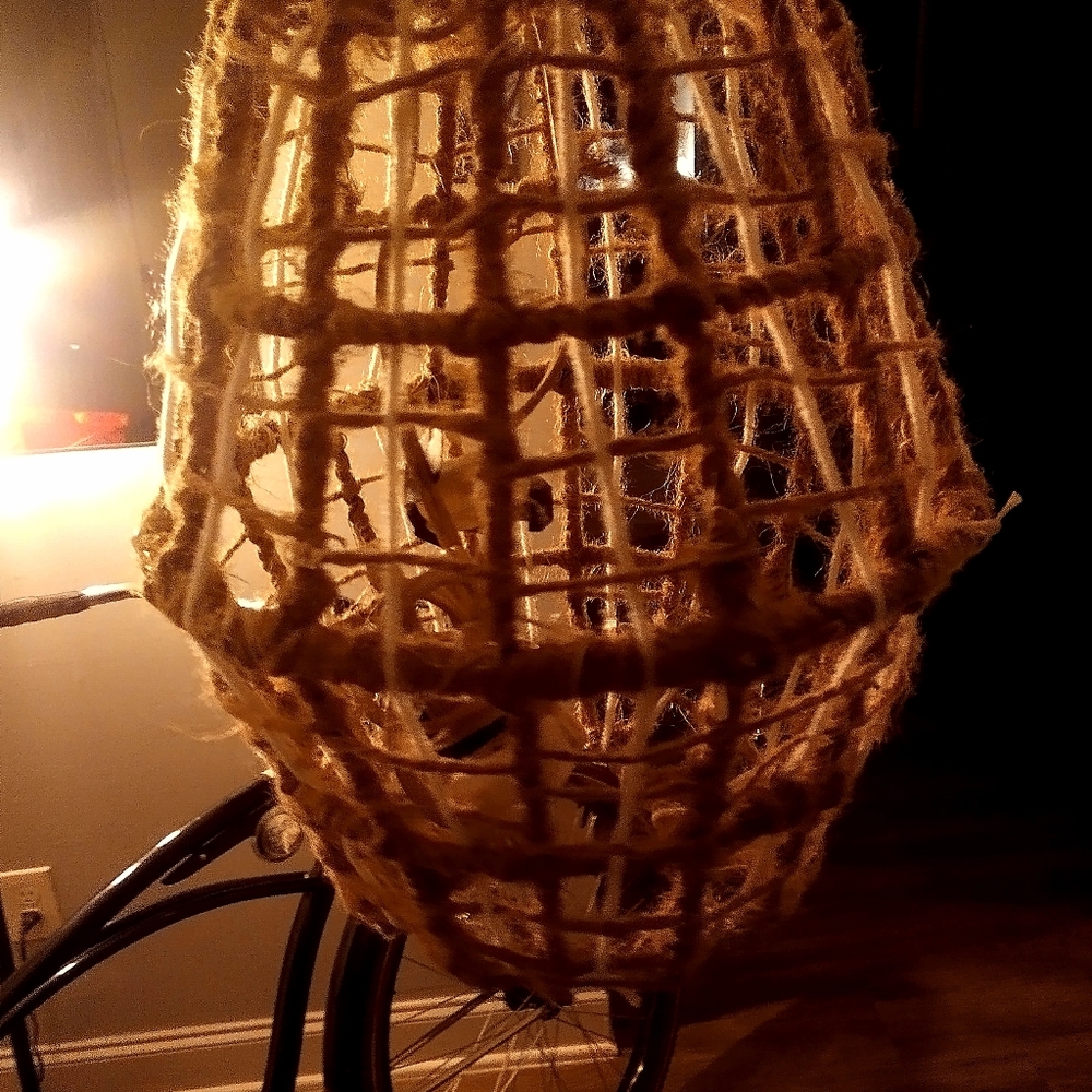 Wire basket wrapped in twine hanging light